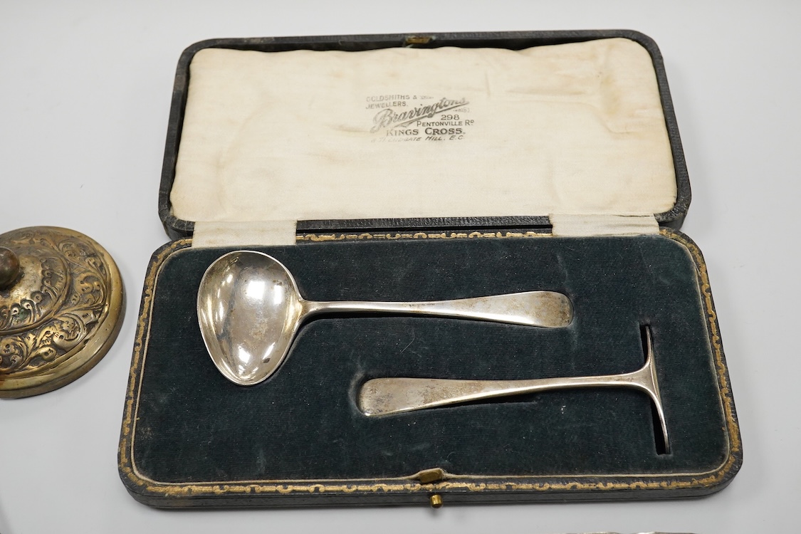 A collection of silver and white metal items, to include a cigarette box, a/f, a German dwarf candlestick, a cased spoon and pusher, etc.